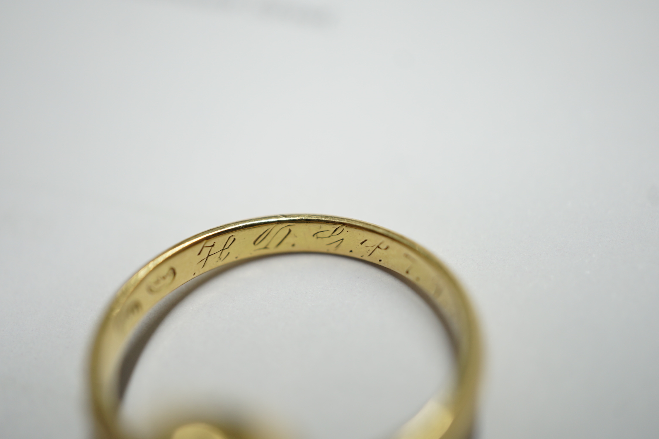 A George V 750 yellow metal and oval cut citrine set ring, size Q, gross weight 5.6 grams.